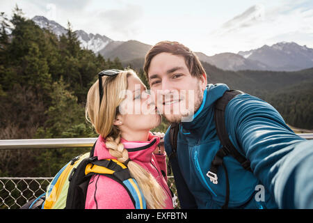 Young hiking couple taking selfie in mountains, Reutte, Tyrol, Austria Stock Photo