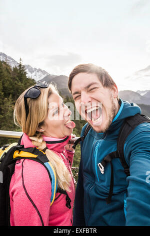 Young hiking couple posing for selfie in mountains, Reutte, Tyrol, Austria Stock Photo