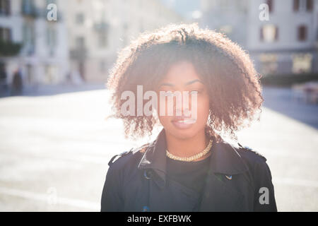 Portrait of stylish young woman in town square Stock Photo