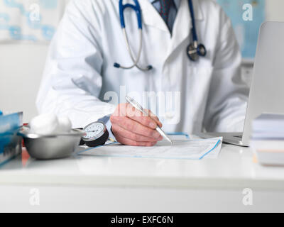 Doctor checking medical notes before prescribing treatment Stock Photo