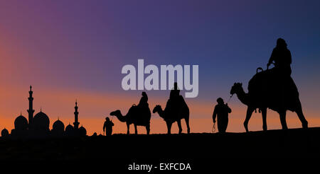 Middle eastern man wearing traditional clothes on desert dune, Dubai,  United Arab Emirates stock photo