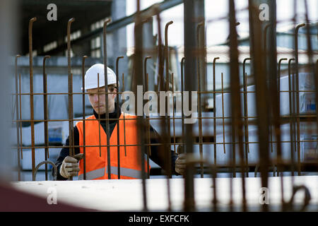 Factory worker choosing wire mesh in concrete reinforcement factory Stock Photo