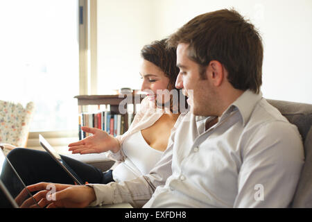 Couple surfing the web at home Stock Photo