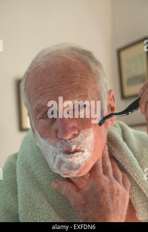 Senior man shaving Stock Photo