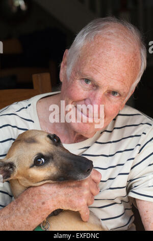 Senior man holding dog Stock Photo