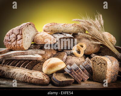 Different types of bread on wooden desk. Stock Photo