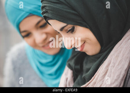 Close up of two young women wearing hijabs Stock Photo