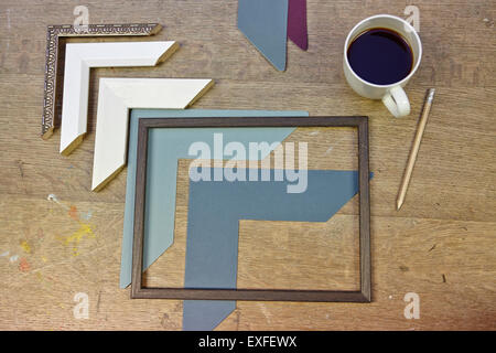 Still life of frames and coffee in picture framers workshop Stock Photo