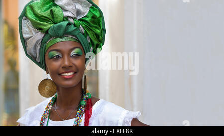 Baiana, smiling Brazilian woman of African descent, wearing traditional attire in Pelourinho, Salvador, Bahia, Brazil. Stock Photo