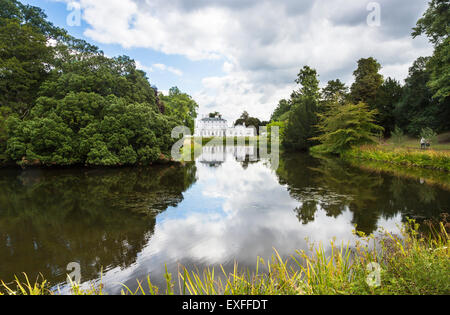 Frogmore House, Windsor, Berkshire, UK with reflections of the blue sky and white fluffy clouds in the lake in summer Stock Photo