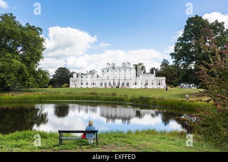 Frogmore House, Windsor, Berkshire, UK with reflections of the blue sky and white fluffy clouds in the lake in summer Stock Photo