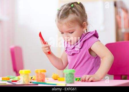 kid girl drawing and making by hands at nursery or kindergarten Stock Photo