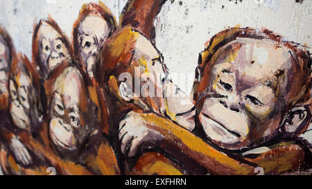 Orangutans in a Wheelbarrow street art mural by Lithuanian artist Ernest Zacharevic in Kuching, Sarawak, Malaysia. Stock Photo