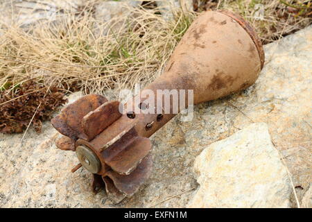 rusty bomb shell case from second world war found in the mountains near the trenches Stock Photo