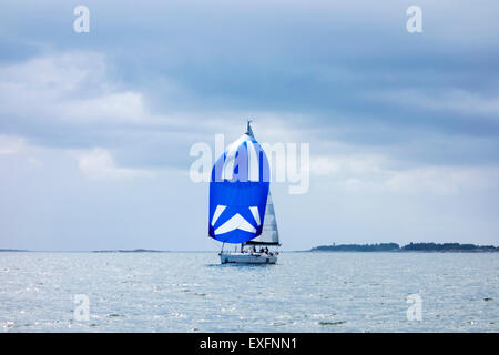 Sailing boat with spinnaker sail set Stock Photo