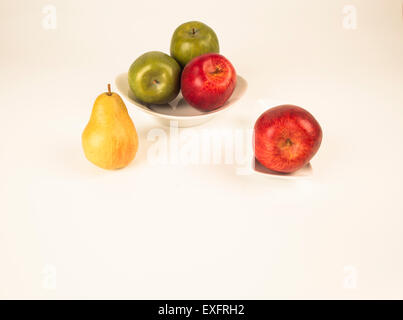 four apples and one pear Stock Photo