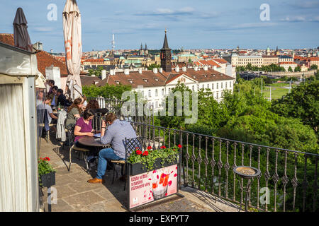 Tourists on the outdoor terrace of a restaurant below the castle,  Prague, Czech Republic, Europe Stock Photo