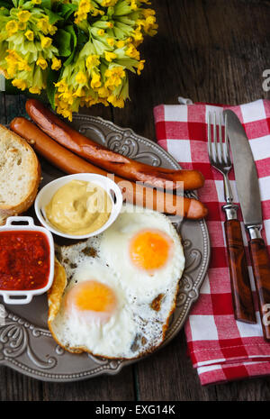 Lunch time with eggs and fried sausages Stock Photo