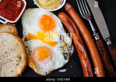 Lunch time with eggs and fried sausages Stock Photo