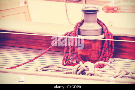 Vintage toned winch with rope on sailing boat, nautical background. Stock Photo