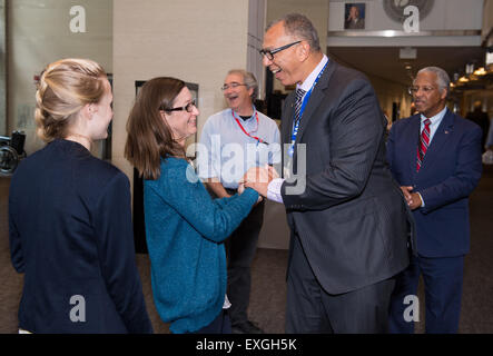 Donald James, associate administrator for education, NASA, congratulates Maureen Pollitz, a teacher from Nicholson Elementary School in Picayune, Miss., and her students who are finalists in the Samsung &quot;Solve for Tomorrow&quot; contest, winning a $120,000 award, on Tuesday, April 28, 2015 at NASA Headquarters in Washington, DC. They built a prototype robot that investigates city drainage systems to identify problems. Stock Photo