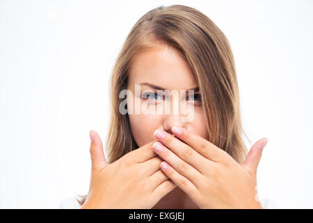 Young woman covering her mouth with hands isolated on a white background Stock Photo