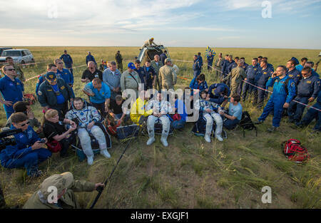 Expedition 43 commander Terry Virts of NASA, left, cosmonaut Anton Shkaplerov of the Russian Federal Space Agency (Roscosmos), center, and Italian astronaut Samantha Cristoforetti from European Space Agency (ESA) sit in chairs outside the Soyuz TMA-15M spacecraft just minutes after they landed in a remote area near the town of Zhezkazgan, Kazakhstan on Thursday, June 11, 2015. Virts, Shkaplerov, and Cristoforetti are returning after more than six months onboard the International Space Station where they served as members of the Expedition 42 and 43 crews. Stock Photo