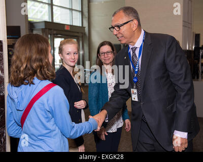 Donald James, associate administrator for education, NASA, congratulates Makayla Stewart, a student from Nicholson Elementary School in Picayune, Miss. and part of the team who are finalists in the Samsung &quot;Solve for Tomorrow&quot; contest, winning a $120,000 award, on Tuesday, April 28, 2015 at NASA Headquarters in Washington, DC. They built a prototype robot that investigates city drainage systems to identify problems. Stock Photo