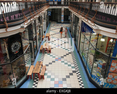 Interior of Barton Arcade a victorian shopping centre in Manchester UK looking to the shops and cafes on the ground floor. Stock Photo