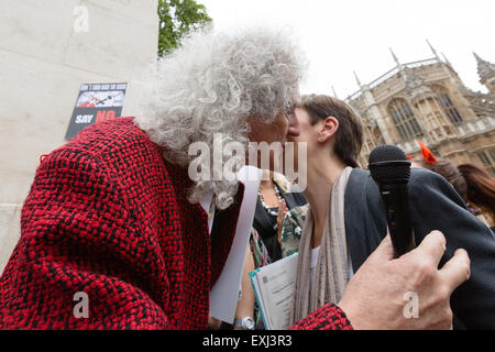 London, UK. 14th July 2015. Brian May greets Caroline Lucas MP at a rally to protest against proposed changes to the Hunting Act, outside the Houses of Parliament in London. On Wednesday, MPÕs will take a free vote on an amendment to the Hunting Act, removing the limit on the number of dogs allowed to flush out foxes and wild animals. Protesters claim that if passed, the amendment would effectively make make fox hunting legal again. Credit:  London pix/Alamy Live News Stock Photo
