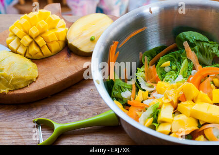 A colourful mango salad with carrot and lettuce Stock Photo