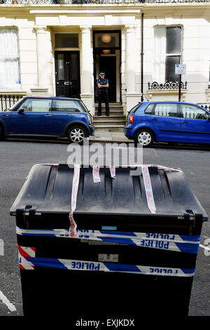 Brighton UK Tuesday 14th July 2015 - Communal rubbish bins taped up for evidence by police near a flat in Chesham Place Kemp Town Brighton where a tourist was believed to have been murdered . Police and ambulance crews were called to the scene in the early hours of Tuesday morning where a man in his 50s who was on holiday was found dead . Another man was arrested on suspicion of murder and is still being questioned Credit:  Simon Dack/Alamy Live News Stock Photo