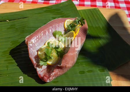 Blue fin tuna belly or Otoro as its known in Japan prepared and waiting to be wrapped in banana leaf for cooking on a barbecue Stock Photo