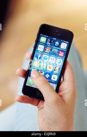 Person browsing through Apps on an iPhone Stock Photo