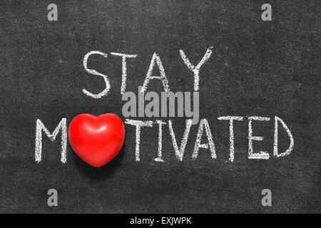 stay motivated phrase handwritten on blackboard with heart symbol instead of O Stock Photo