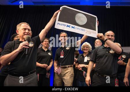 Laurel, Maryland, USA. 14th July, 2015. New Horizons Principal Investigator Alan Stern, left, Johns Hopkins University APL Director Ralph Semmel, center, and New Horizons Co-Investigator Will Grundy hold a print of an U.S. stamp with their suggested update since the New Horizons spacecraft has now explored Pluto July 14, 2015 in Laurel, Maryland.