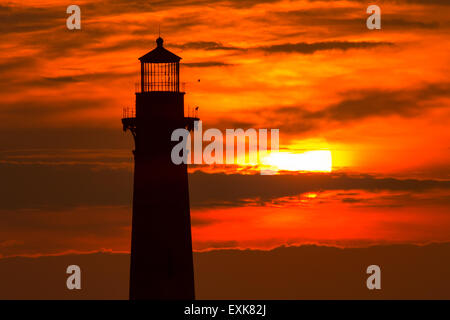 Sunrise over Morris Island Light house seen from Folly Beach July 13, 2015 in Folly Beach, SC. Morris Lighthouse dates back to 1767 and the land around it slowly eroded until it now sits completely surrounded by water. Stock Photo