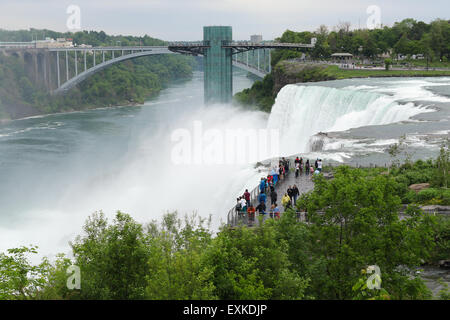 Luna Island at the American Falls. Observation Deck and Rainbow Bridge in the background. Niagara Falls, New York, USA. Stock Photo