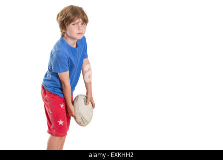 Young boy posing with rugby league ball pretending to throw it, with lots of copy space. Stock Photo