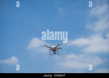 Quadcopter flying in the clouded sky, Tokyo, Japan Stock Photo