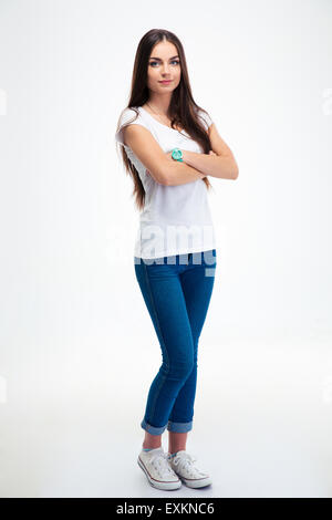 Full length portrait of a beautful happy woman standing with arms folded isolated on a white background. Looking at camera Stock Photo