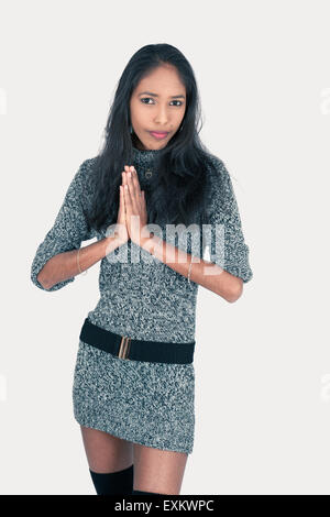 Beautiful woman doing different expressions in different sets of clothes: praying Stock Photo