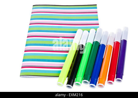 Work book with set of colorful pencils, isolated on white Stock Photo