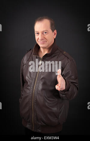 Handsome man doing different expressions in different sets of clothes: gun sign Stock Photo