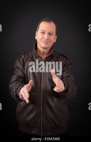 Handsome man doing different expressions in different sets of clothes: gun sign Stock Photo
