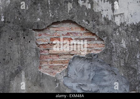 Old brick wall partially damaged Stock Photo
