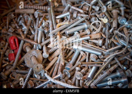 a heap of screws in the workroom Stock Photo