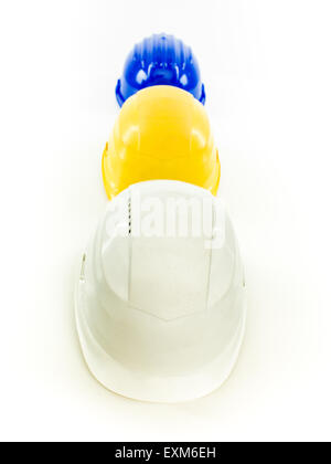 three multi colored protective helmets in a row, on white background