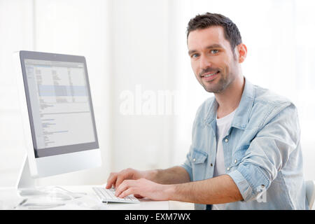 View of a young relaxed man using computer Stock Photo
