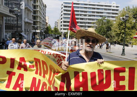 Athens, Greece. 15th July 2015. A protester marches in the Union's anti-austerity protest. Greek Unions have called for a 24h strike on the day, the Greek Parliament is going to vote on the new austerity measures, the creditors of Greece have imposed as a precondition for the start of the discussion about the 3rd bailout program for Greece. Stock Photo